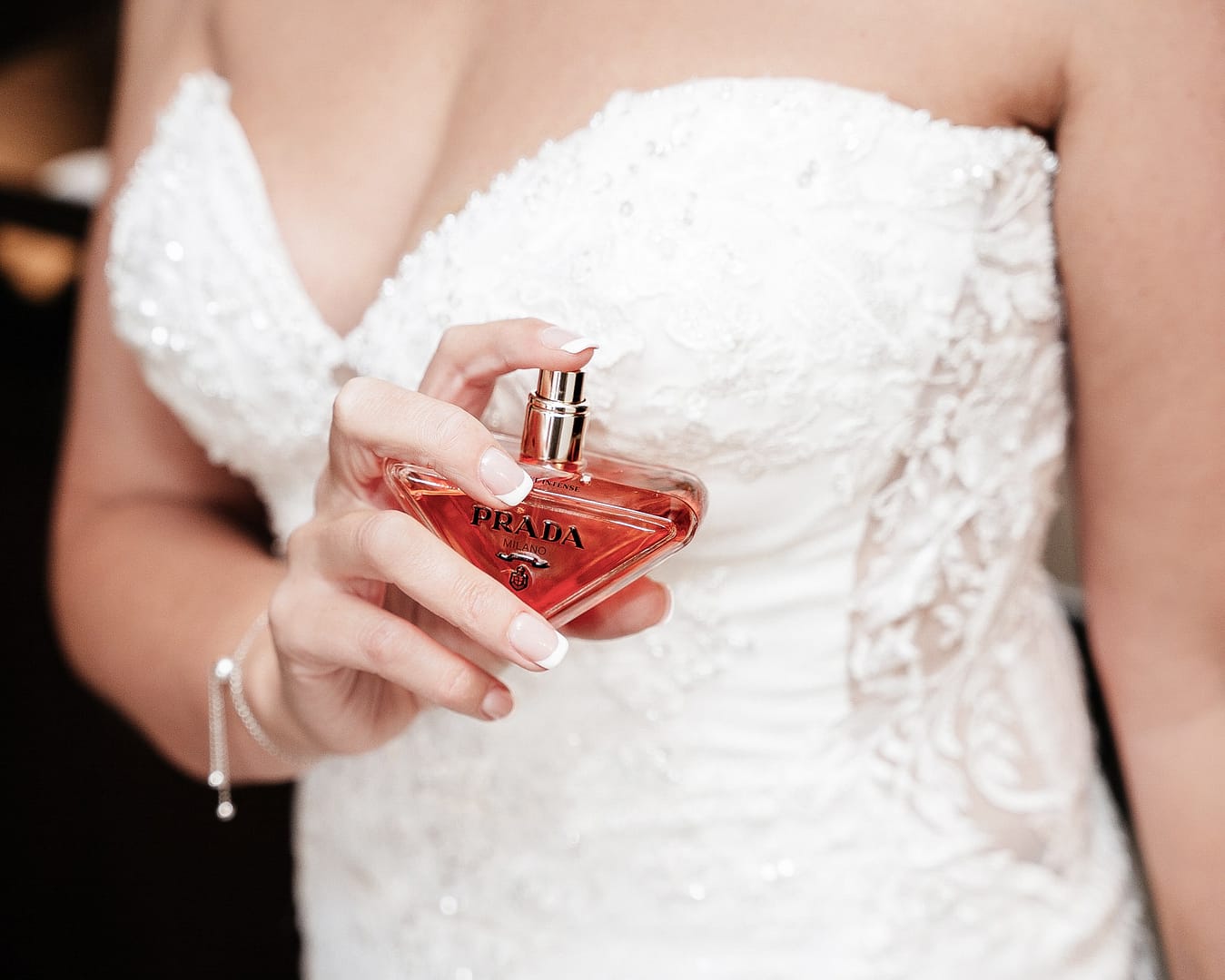bride holding prada perfume