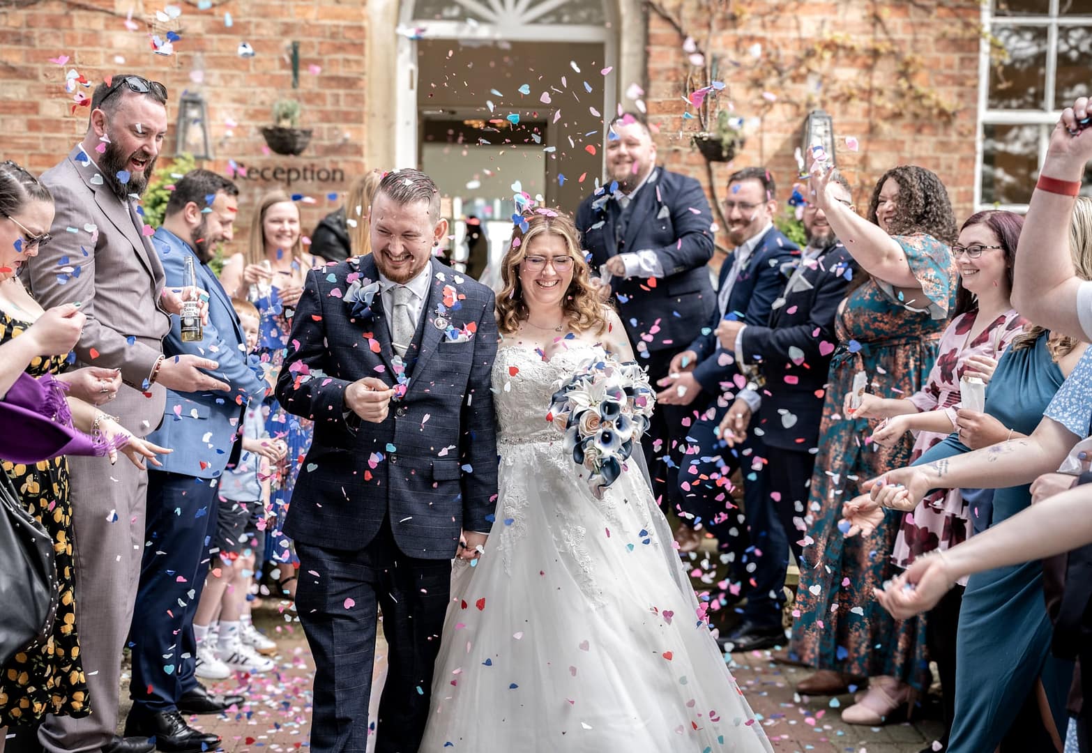 bride and groom going through confetti tunnel