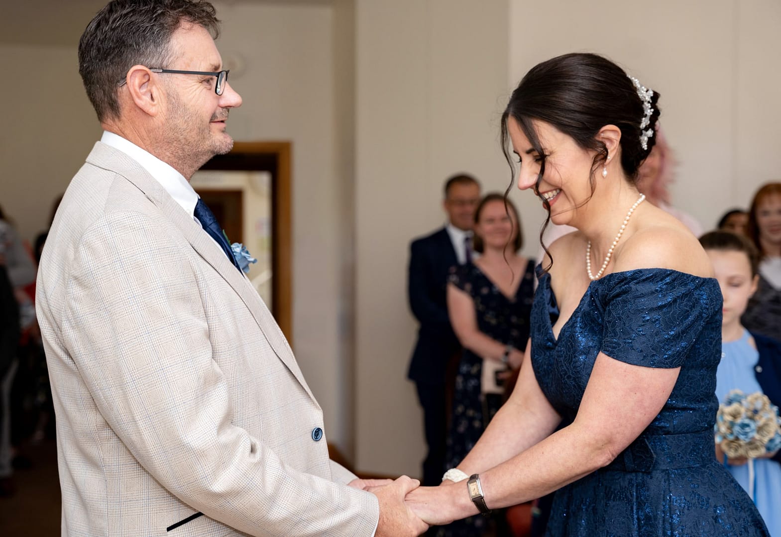 bride and groom holding hands at st albans registry office