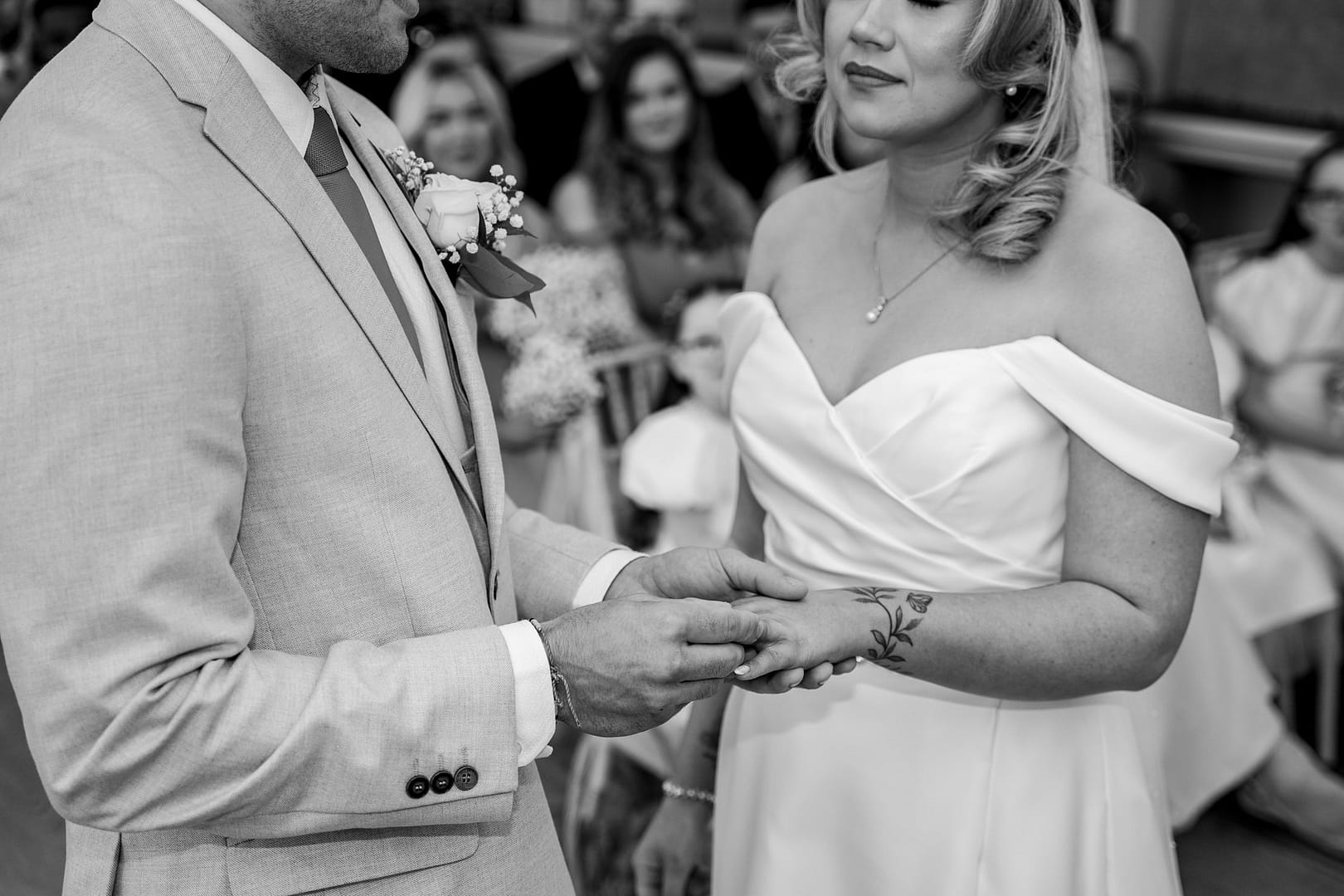 bride and groom exchanging rings at shenley cricket club