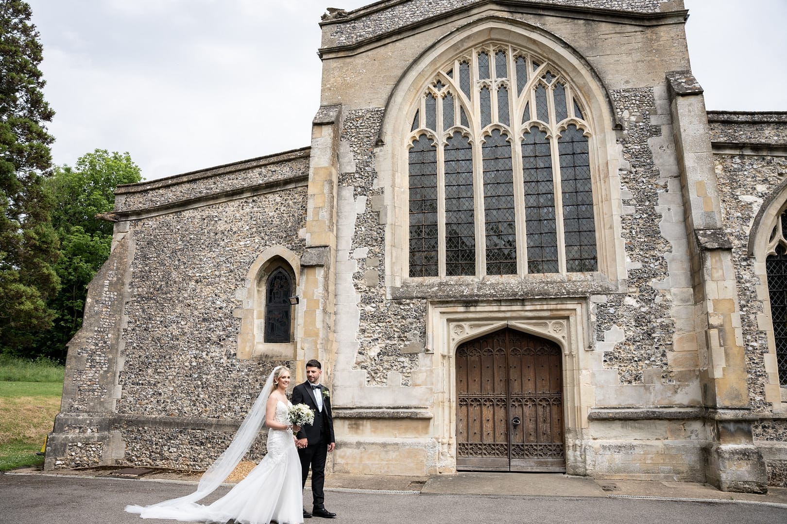 bride and groom in front of church