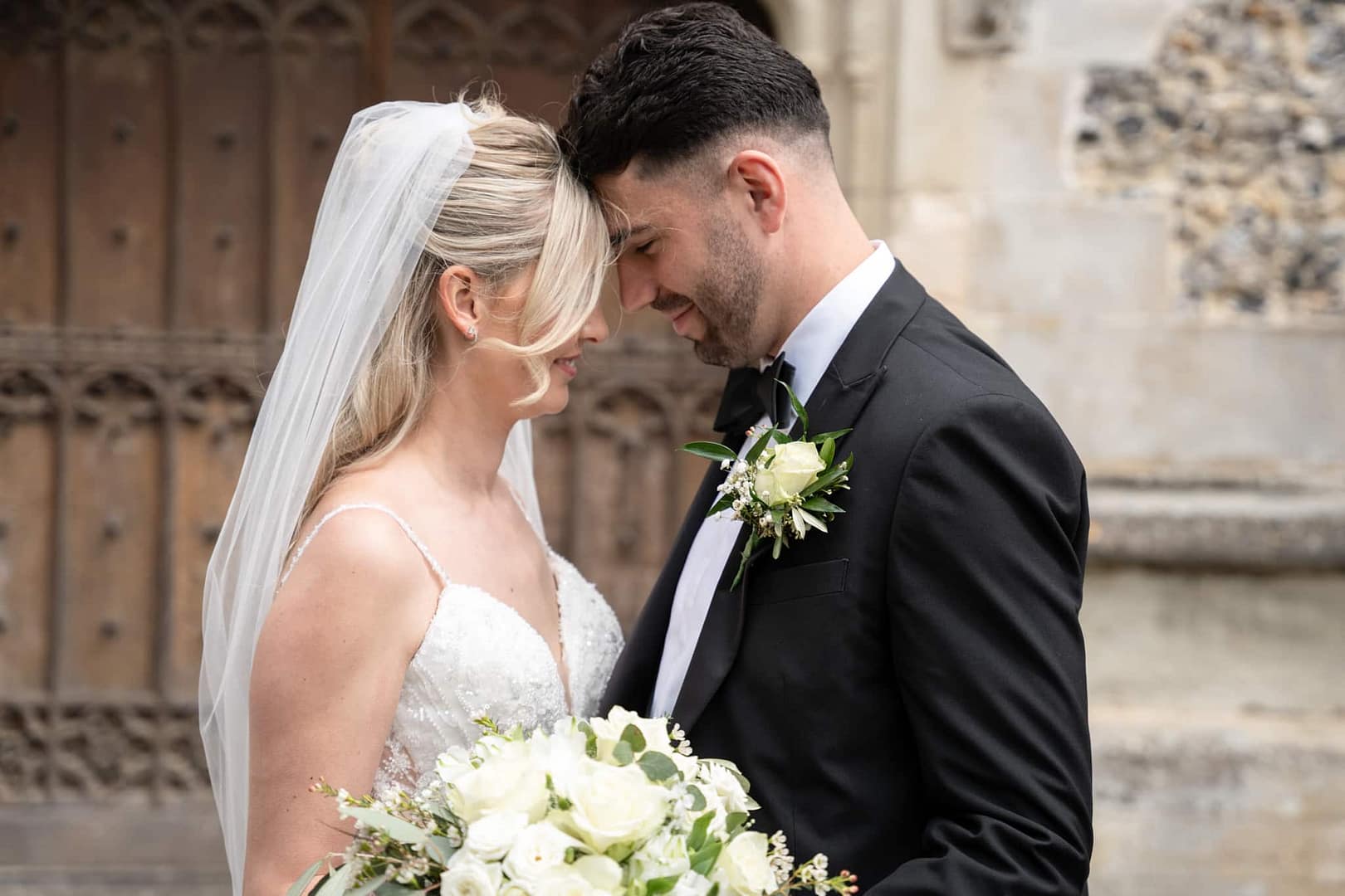bride and groom touching forehead’s