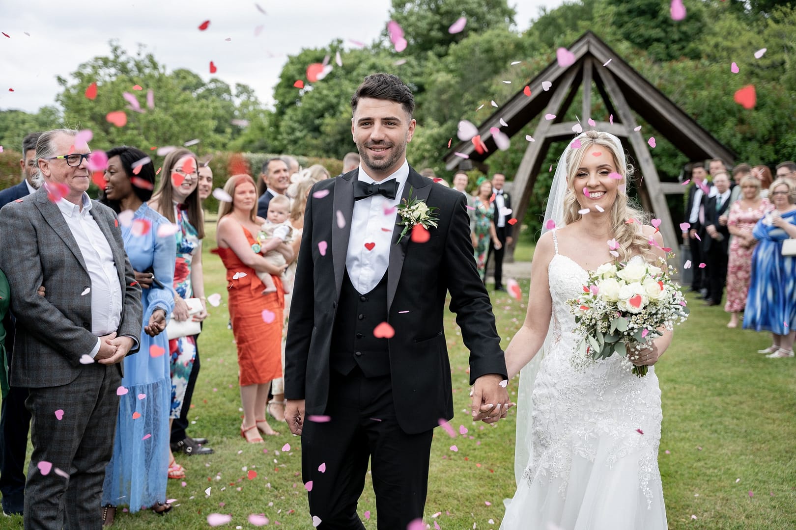 bride and groom under a shower of confetti