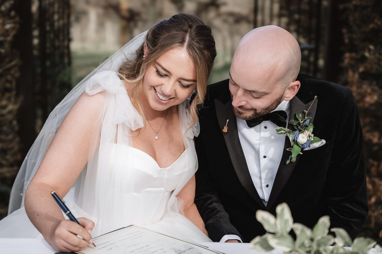 bride and groom signing registrar