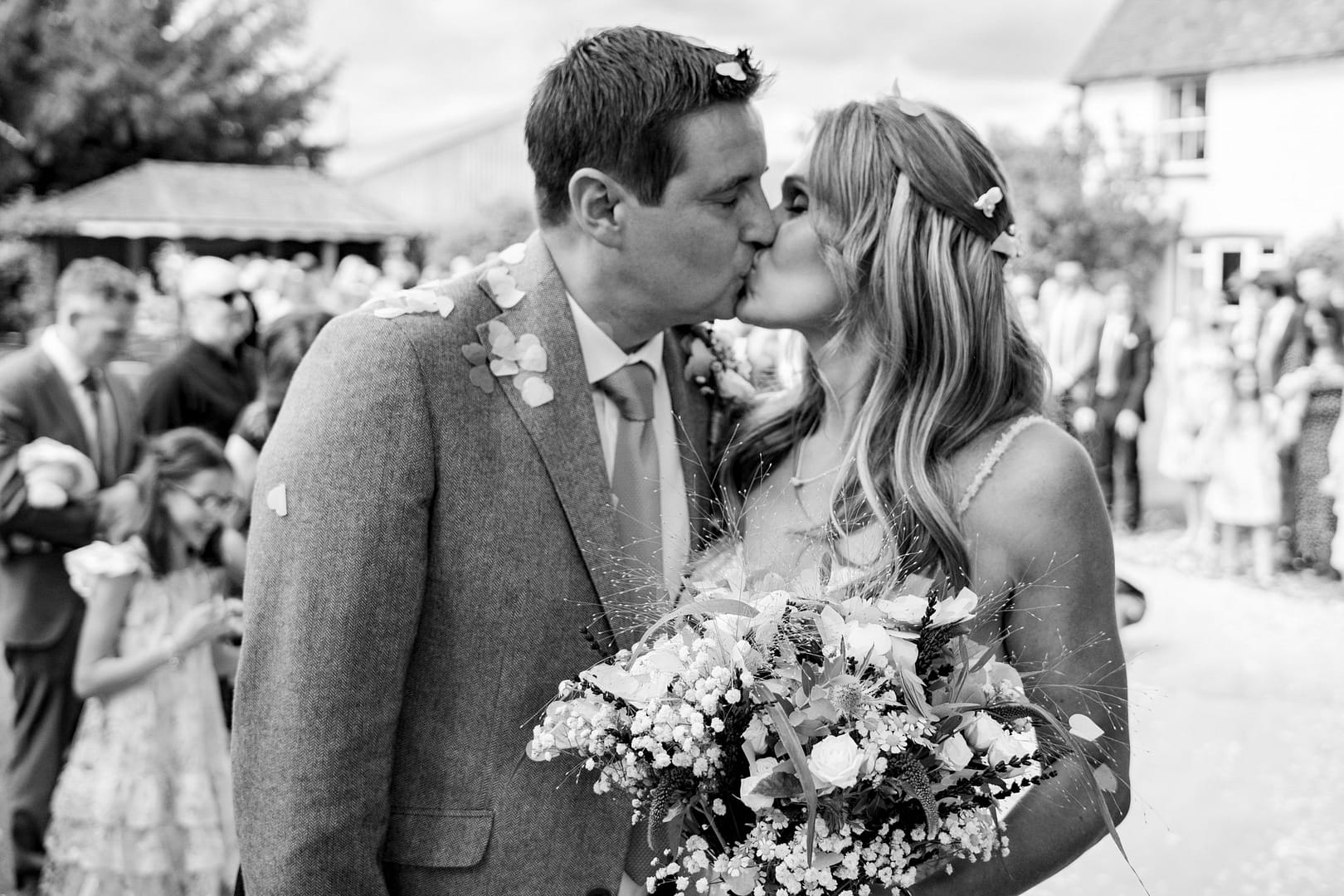 bride and groom kissing in black and white