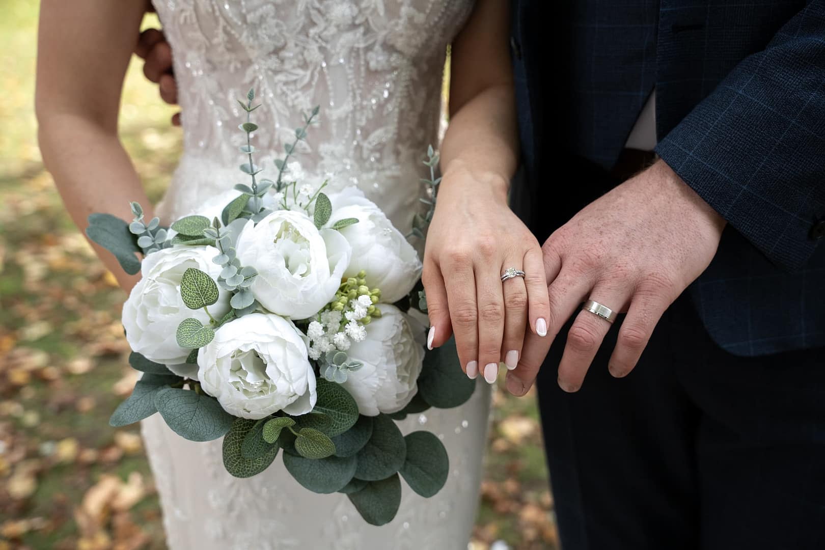 bride and groom showing wedding rings