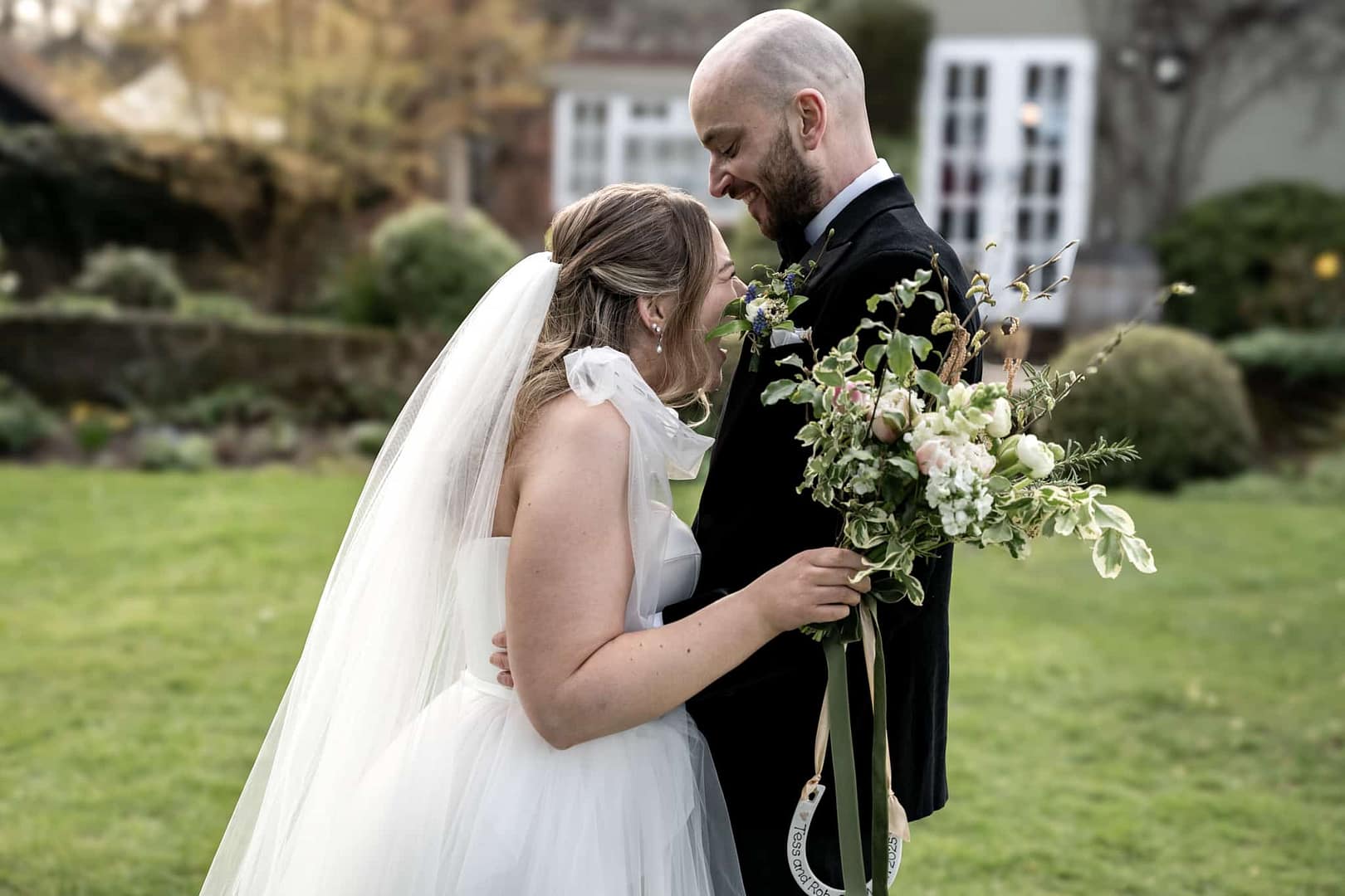 bride and groom laughing at old luxters barn