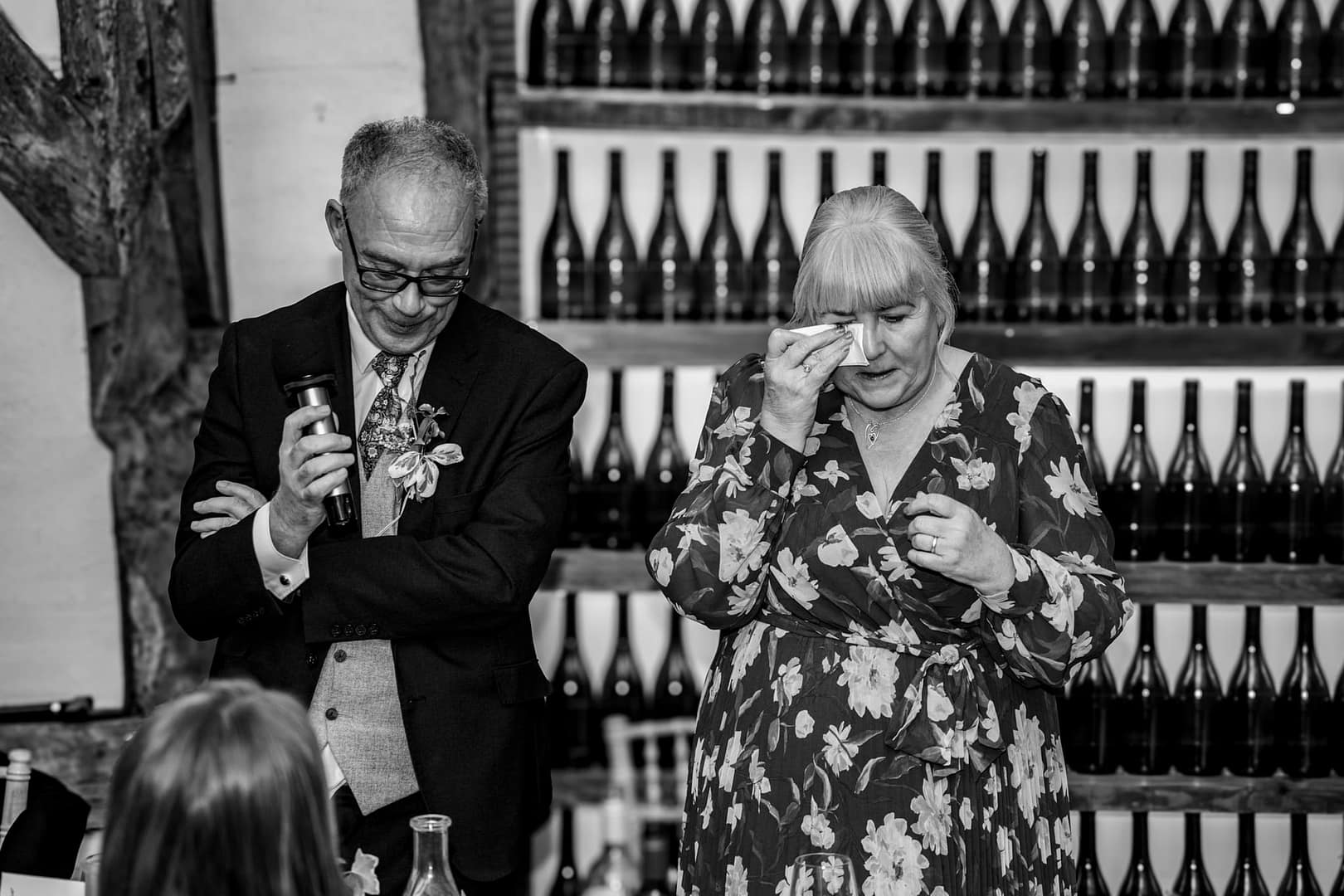 Couple speaking at a celebration.at old luxters barn