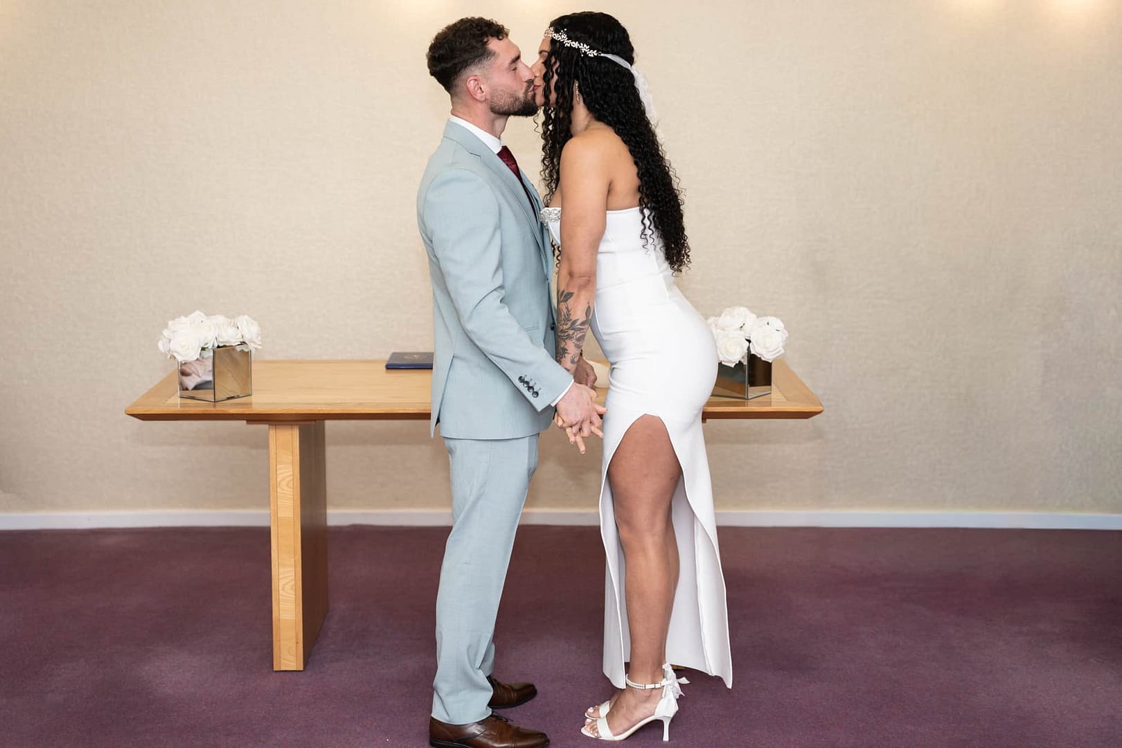 Bride and groom kissing at wedding ceremony