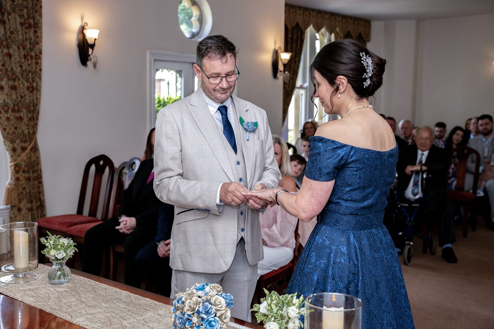 bride and groom exchanging rings at st albans registry office