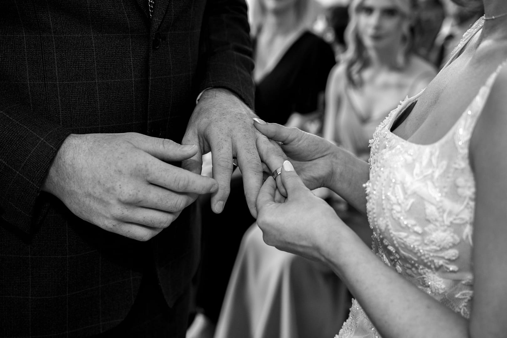 bride and groom exchanging rings