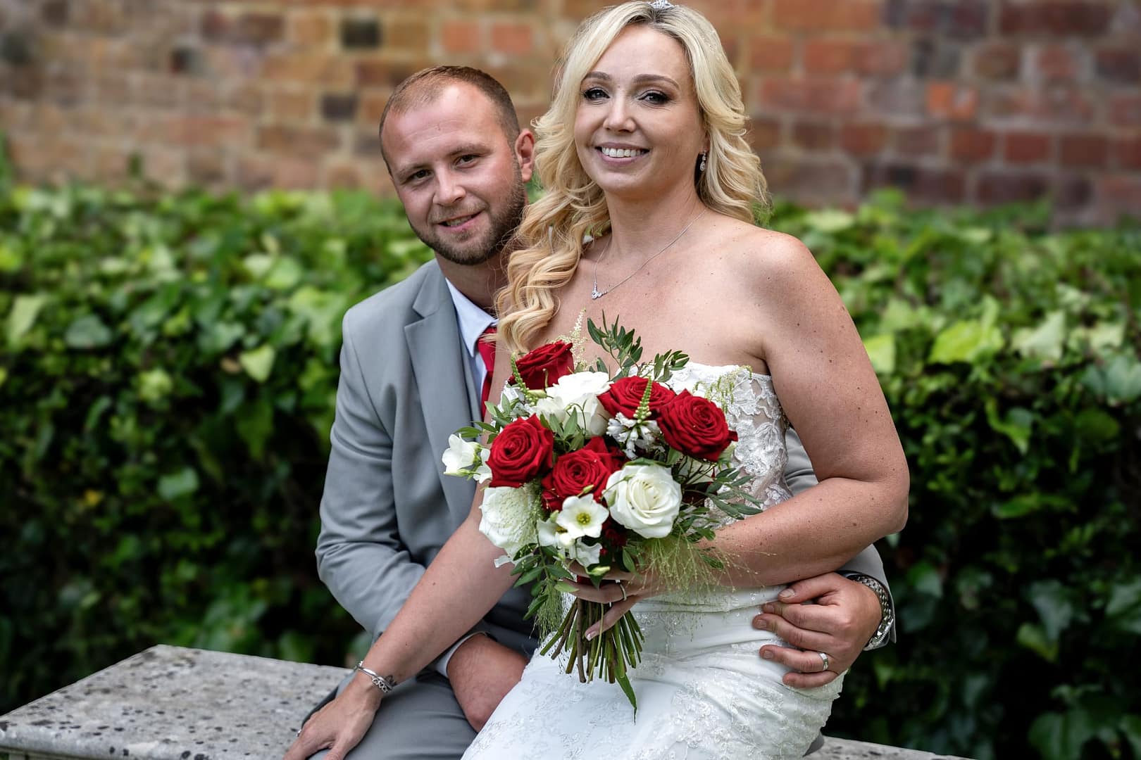 bride sitting on grooms lap at the gatehouse st albans