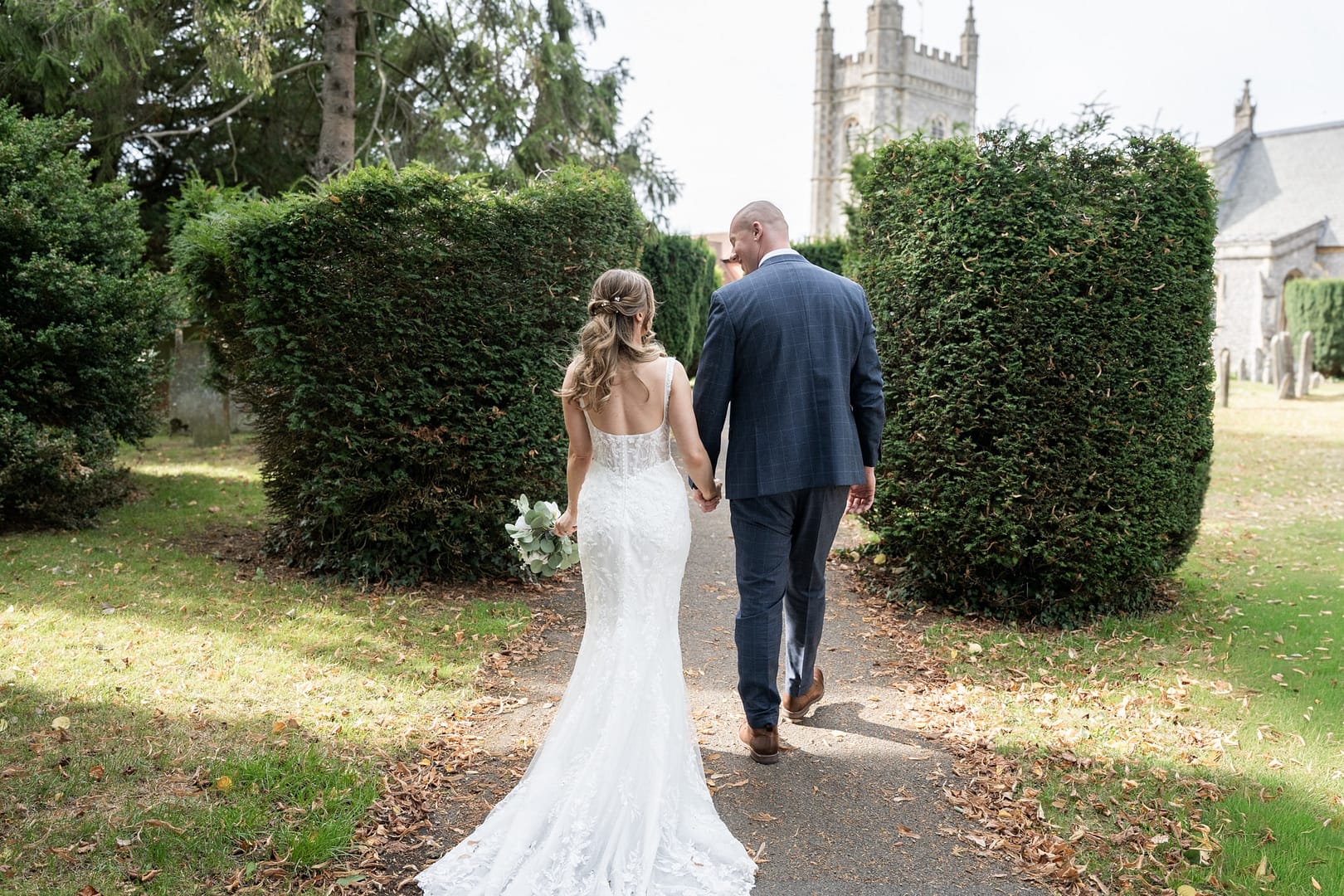 bride and groom holding hands near beaconsfield registry office
