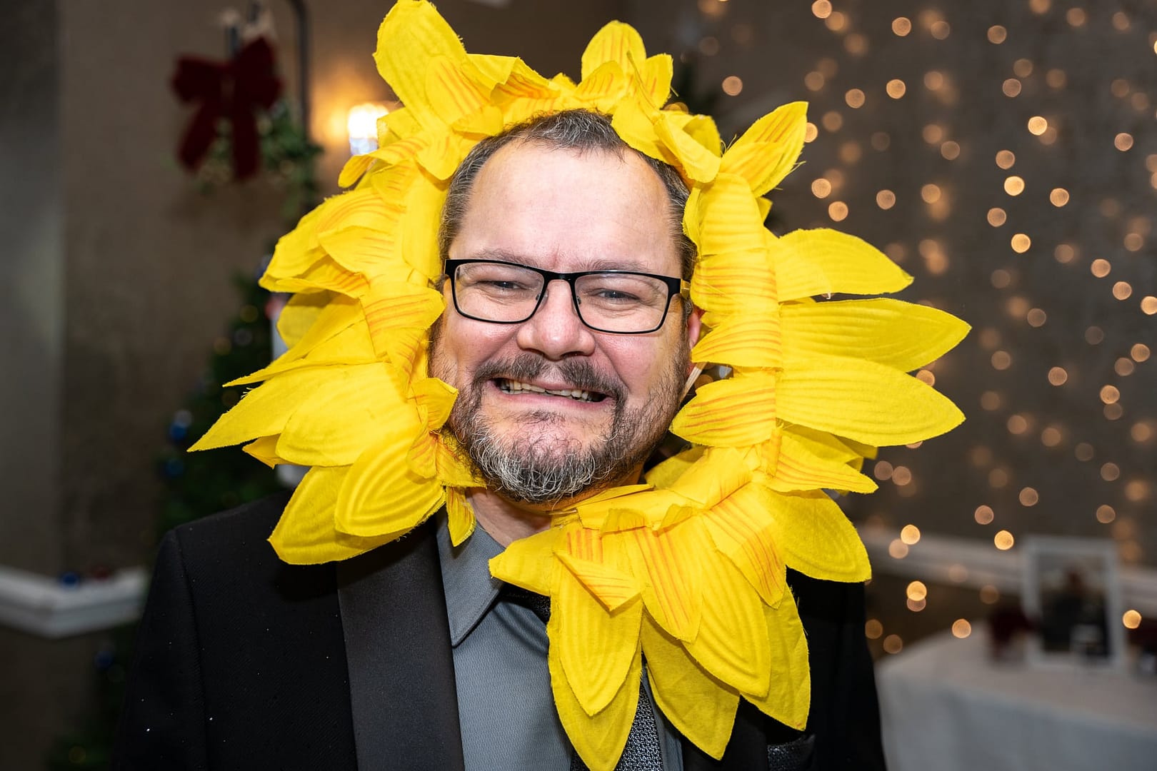 man in sunflower hat at event