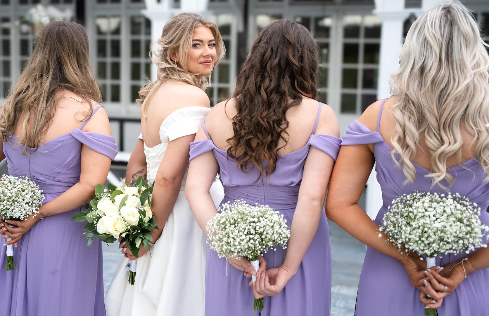 Bridesmaids in lavender colour dresses with bride