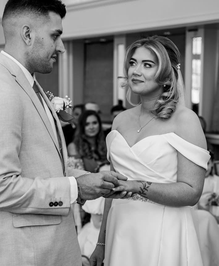 bride and groom exchanging rings